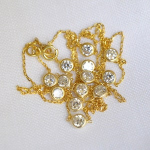 Close-up of a gold plated chain with clustered CZ stones, showcasing the clarity, brilliant sparkle, and precise cuts of the diamonds.