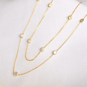 Close-up of a gold-colored chain with clustered CZ stones, showcasing the clarity, brilliant sparkle, and precise cuts of the diamonds.