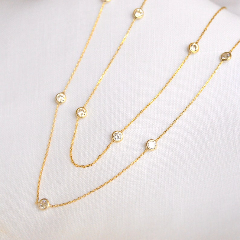 Close-up of a gold-colored chain with clustered CZ stones, showcasing the clarity, brilliant sparkle, and precise cuts of the diamonds.