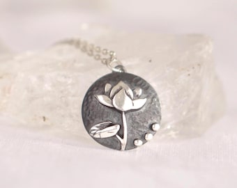 Sterling silver July waterlily birth flower necklace featuring a handmade botanical pendant in a round charm design