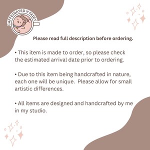 May include: Text on a light brown background with a pink and white cartoon image of a caffeinated fairy. The text reads "Please read full description before ordering."  "This item is made to order, so please check the estimated arrival date prior to ordering."  "Due to this item being handcrafted in nature, each one will be unique. Please allow for small artistic differences."  "All items are designed and handcrafted by me in my studio."