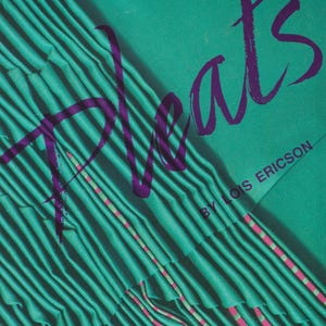 May include: A teal and purple graphic design featuring the word "Pleats" in a stylized purple font. The background is a teal fabric with vertical pleats. The text "BY LOIS ERICSON" is also visible.