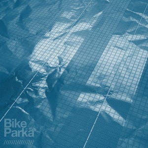 May include: Blue-toned image with a grid pattern overlaying a textured surface. The words "Bike Parka" are visible in the lower left corner. The overall effect suggests a product designed for bicycle protection.