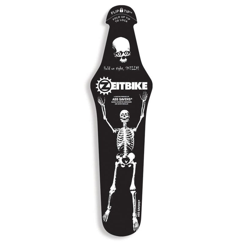 May include: A black bicycle fender with a white skeleton graphic. The fender has the text "ZEITBIKE" and "ASS SAVERS". The top of the fender reads "FLIP TIP" and "FOLD UP TIP TO LOCK". The text "Hold on tight, SKELLY!" is also present.