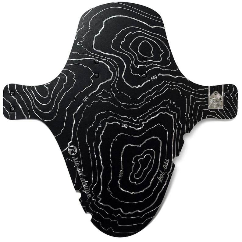 May include: Black bicycle fender with a topographic map design in silver. The fender has a unique shape with extended side flaps and a rear mounting tab. The text "rie:sel design" and "kol:ass" are visible. The fender is labeled "MADE IN GERMANY ORIGINAL".