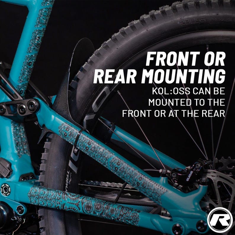 May include: Close-up of a teal mountain bike frame with black and gray accents. The frame has a decorative pattern. The text "FRONT OR REAR MOUNTING" is displayed, with additional text below indicating the product can be mounted on the front or rear.