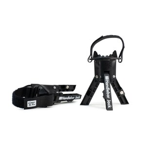 May include: Two black Handlebar Jack bicycle accessories are displayed against a white background. One is a strap with a velcro closure and the other is a tripod-like stand. The Handlebar Jack logo is visible on both.