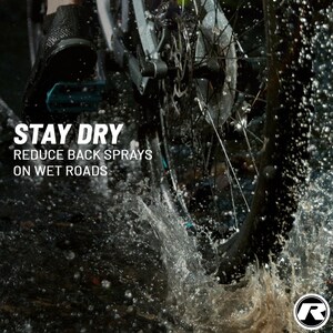 May include: A close-up shot of a bicycle wheel splashing through water. The image features the text "STAY DRY, REDUCE BACK SPRAYS ON WET ROADS." The wheel is black and silver, with water droplets and spray visible.