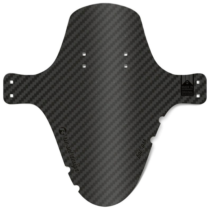 May include: A black carbon fiber bicycle fender with a textured weave pattern. The fender has a unique shape with mounting holes and the text "kol ass" and "riesel design". The product is labeled "Made in Germany Original".
