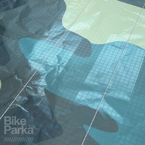 May include: Close-up of a camouflage pattern in shades of teal, blue, and yellow-green. The fabric has a grid-like texture with the text "Bike Parka" in the lower left corner.