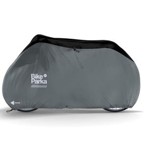 May include: A gray Bike Parka XL bicycle cover. The cover is designed to fully enclose a bicycle, with a black top section and a zipper closure. The text "Bike Parka XL" is printed on the side, along with the word "FRONT" and an arrow.
