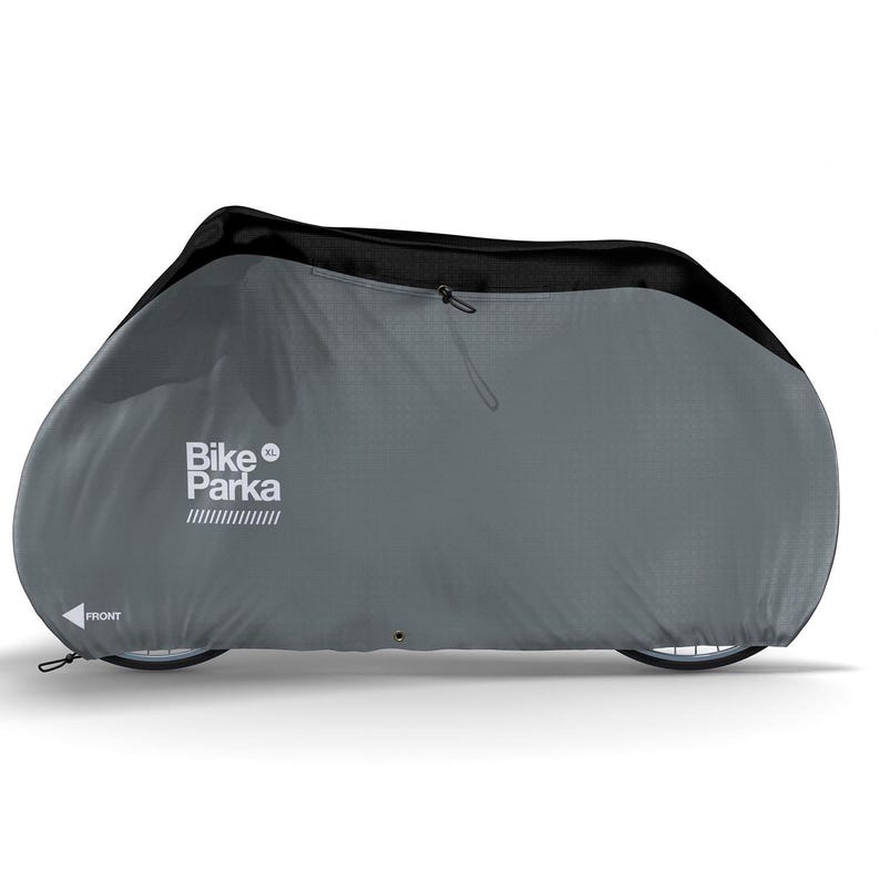 May include: A gray Bike Parka XL bicycle cover. The cover is designed to fully enclose a bicycle, with a black top section and a zipper closure. The text "Bike Parka XL" is printed on the side, along with the word "FRONT" and an arrow.