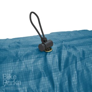 May include: Close-up of a blue tarp with a black cord and stopper. The tarp has a grid pattern and the text "Bike Parka" in white. The cord is attached to the tarp with a gold-colored grommet.