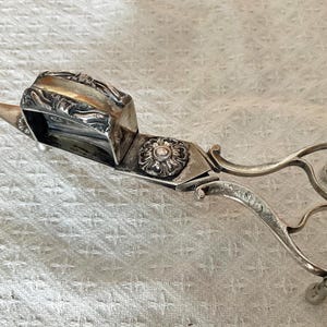 Victorian ornate candle snuffer/letter opener hall marked.  Slight misalignment of handles.