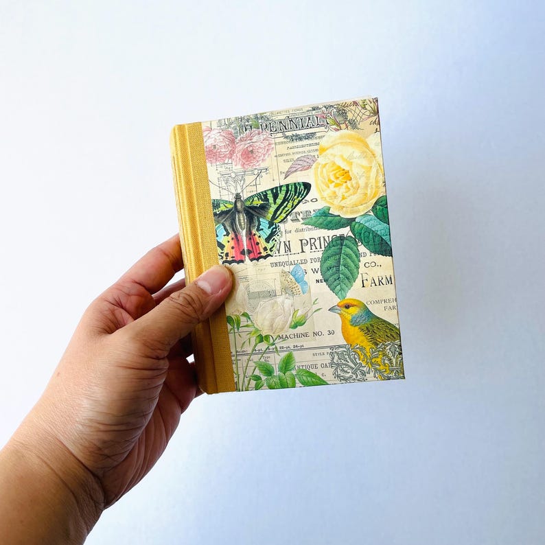 May include: A small, yellow journal with a floral design. The cover features a butterfly, a bird, and a yellow rose. The text on the cover reads "PENINTZOGEN", "N PRING", "UNEQUALLED FOR", "W", "NE", "MACHINE NO. 30", "D", "Co..", "FARM", "COMPREH", "FAR", and "NTIQUE GATE".