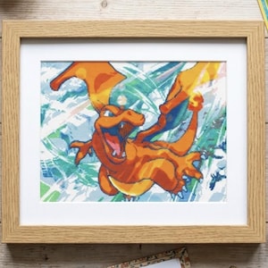 May include: A framed cross-stitch pattern featuring the orange dragon-like creature Charizard in a dynamic pose against a blue and white abstract background, surrounded by embroidery floss bobbins, needles, and small character pins.