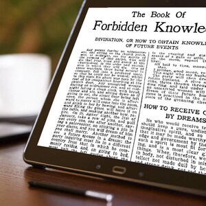 May include: A black tablet displays text from "The Book of Forbidden Knowledge." The text is in black font on a white background. The tablet is on a wooden surface.