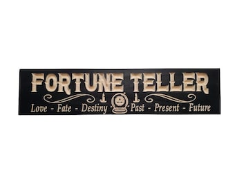 May include: Black wooden sign with the words "Fortune Teller" in a decorative font. The sign also includes the words "Love - Fate - Destiny - Past - Present - Future" and a stylized image of a crystal ball.