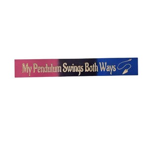 May include: A rectangular sign with a pink, black, and blue gradient background. The text "My Pendulum Swings Both Ways" is in gold lettering. A gold pendulum design is on the right side of the sign.
