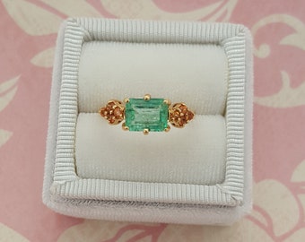 Colombian Emerald Ring Accented With Genuine Orange Sapphires On Each Side, Set in a 14 kt Yellow Gold Handmade Designer Ring