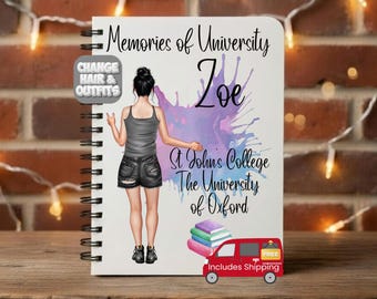 May include: A spiral-bound notebook with the text "Memories of University" and the name "Zoe" in black script. The notebook features a watercolor splash design in purple and blue, and an illustration of a person. The notebook also includes the text "St John's College The University of Oxford".