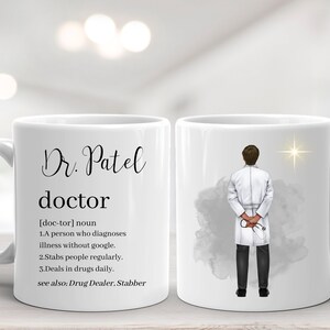 May include: White ceramic mug with the name "Dr. Patel" and the definition of "doctor". The mug features an illustration of a doctor and a star. The text includes humorous definitions of a doctor.
