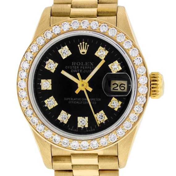 gold rolex with black face and diamonds