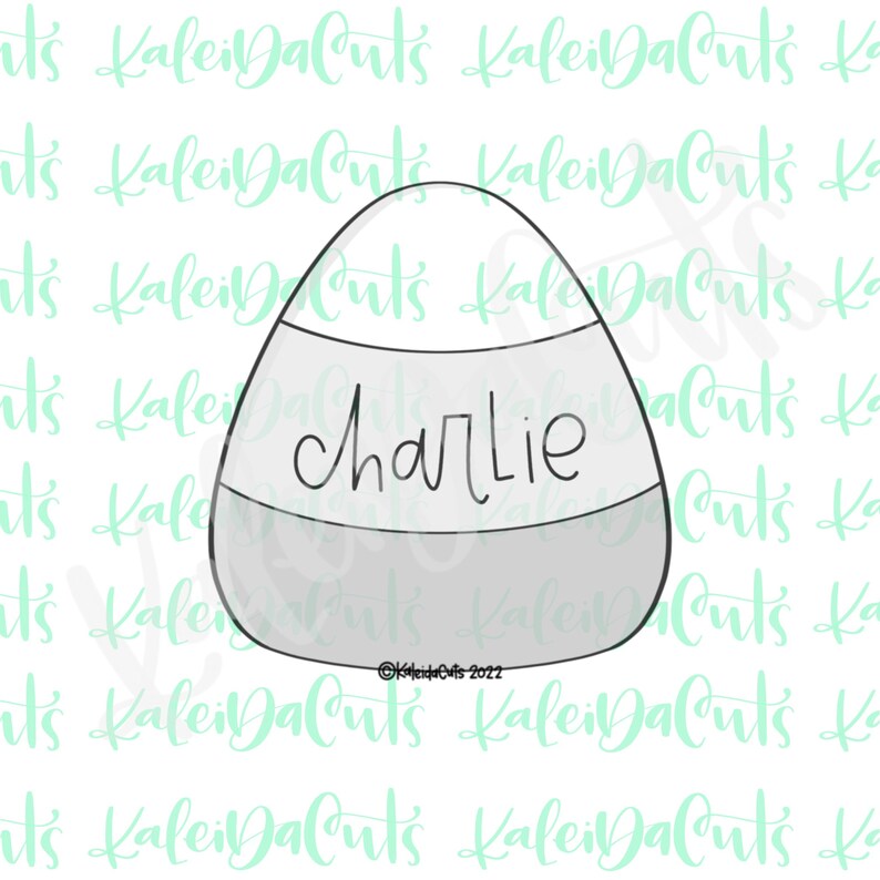 May include: A white, orange, and gray candy corn cookie cutter with the name "Charlie" written on the orange section.