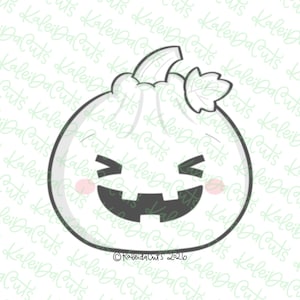 May include: A white pumpkin cookie cutter with a dark gray outline, featuring a carved jack-o'-lantern face with closed eyes, a wide grinning mouth, and two small pink circles on the cheeks. A stem and a single leaf are at the top.