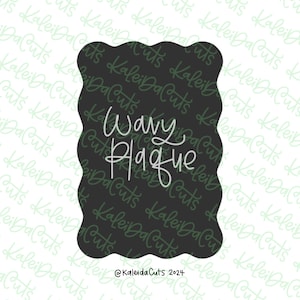 May include: A black wavy plaque with the text "Wavy Plaque" in white cursive lettering. The plaque has a scalloped edge and the text "@KaleidaCuts 2024" is at the bottom.