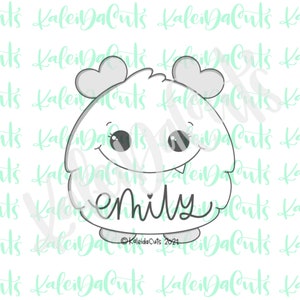 May include: A black and white line art cookie cutter in the shape of a monster with two horns, big eyes, and a toothy grin. The monster has the name "emily" written underneath it.