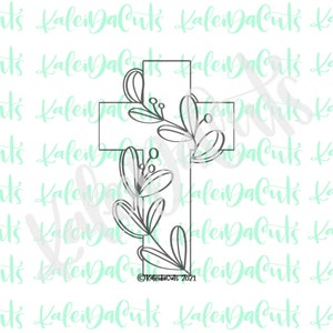 May include: A black outline of a cross decorated with floral elements. The cross is adorned with leaves and berries, creating a decorative design. The text "KaleiDaCuts 2021" is visible at the bottom.