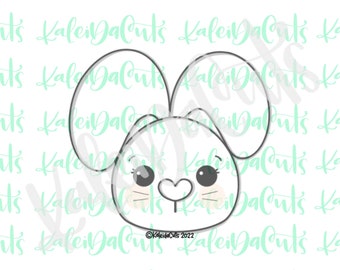 May include: A black and white line drawing of a bunny rabbit's face with large ears, big eyes, and a heart-shaped nose. The bunny has blush on its cheeks.