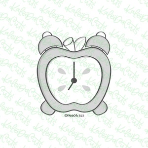 May include: A gray alarm clock shaped like an apple with a white face and black hands. The clock has a stem and leaf on top.