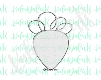 May include: A gray outline of a carrot cookie cutter with a leafy top.
