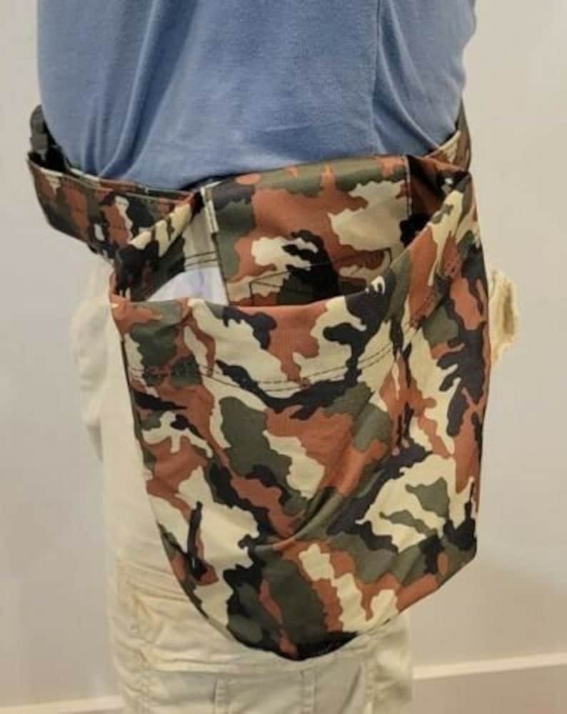 May include: A camouflage-patterned utility pouch with a zippered closure. The pouch is worn around the waist and has a large pocket on the front.