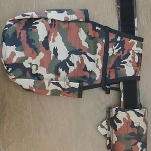 May include: A camouflage-patterned belt with a matching pouch and a small side pocket. The belt has a black buckle and a black strap.