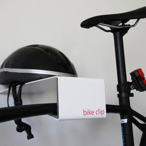 white BIKE CLIP - a wall mounted bike rack, bike shelf, bicycle storage, minimal steel bike hanger, modern bike clip, gift for cyclist
