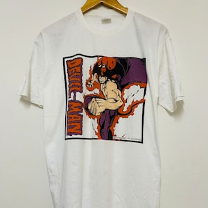 May include: White t-shirt with a graphic print of a red and purple demon character with the text "Devil-Man" and "Dynamic Planning" on the front.