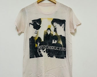 May include: A vintage white t-shirt with a black and white image of The Psychedelic Furs band members. The band's name is printed in black and yellow across the bottom of the image.
