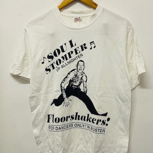 May include: White t-shirt with a black graphic print of a person dancing. The text on the shirt reads "Soul Stomper Up Allnighter Floorshakers! For Dancers Only! W.Buster"