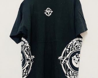 May include: Black t-shirt with a white graphic print of a skateboarder and the text "SK8MAFIA" on the front and back. The back also features a small white graphic of a skull with a crossbones.