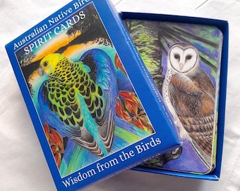 May include: A blue box with the text "Australian Native Bird Spirit Cards" and "Wisdom from the Birds" on the front. The box is open, revealing a deck of cards with colorful illustrations of birds.