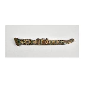 May include: A decorative knife with a white handle and blade, decorated with colorful enamel and a stylized bird design.