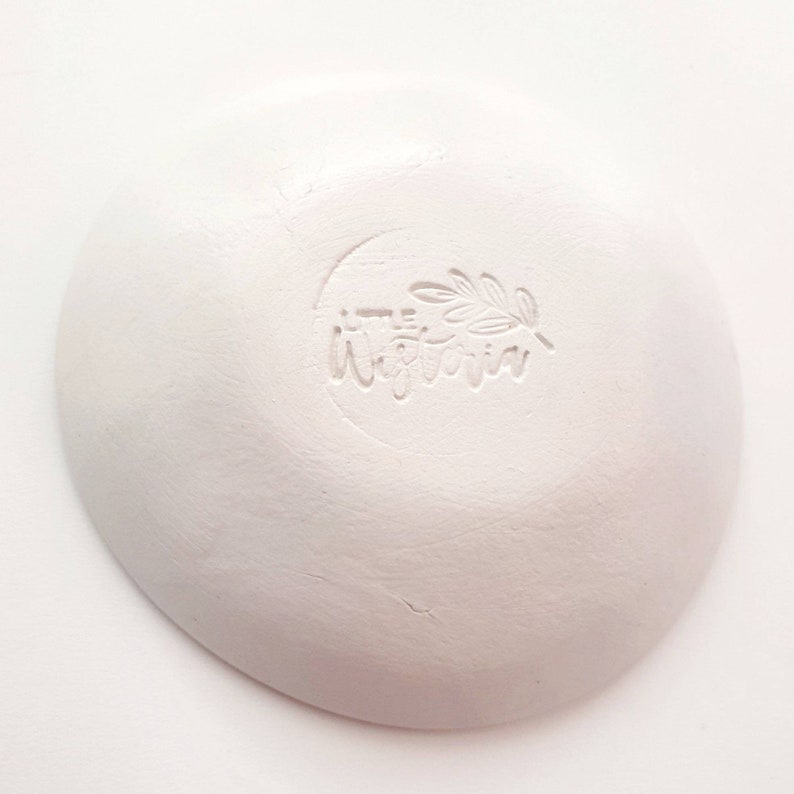 May include: White ceramic dish with a small, embossed logo that reads "the little victoria" with a leaf design.
