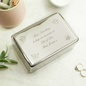 May include: Silver keepsake box with a beaded border and engraved butterflies. The box has a personalised message that reads "Mum, Something to keep our memories in. Lots of Love From Jessica a".