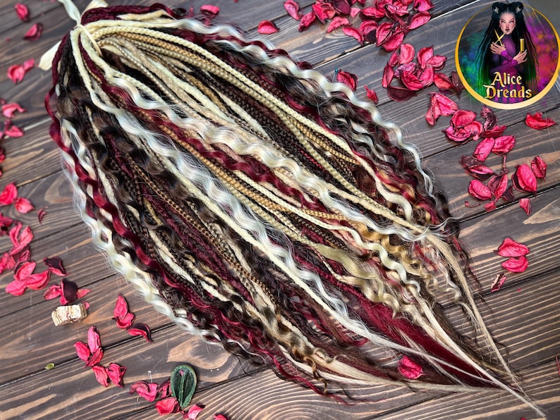 May include: A set of synthetic dreadlocks in a variety of colors, including brown, blonde, and burgundy. The dreadlocks are arranged in a loose, flowing style.