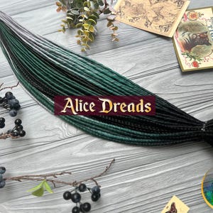 Set of thin synthetic dreads black and ombre green dreads with silver gray ends with braids and twists dark emerad dreadlocks