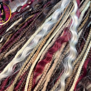 May include: A collection of synthetic dreadlocks in various shades of brown, blonde, and burgundy. The dreadlocks are wavy and have a natural, textured appearance.