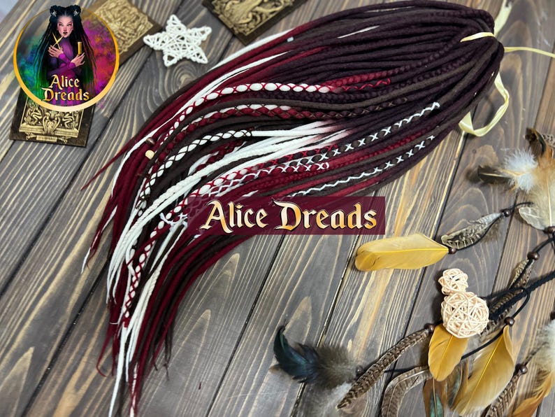 Wool dreads in shades of brown, burgundy, and white with thread-wrapped accents. DE or SE styles in 45-60 cm lengths. Ideal for rustic or festival-inspired looks.